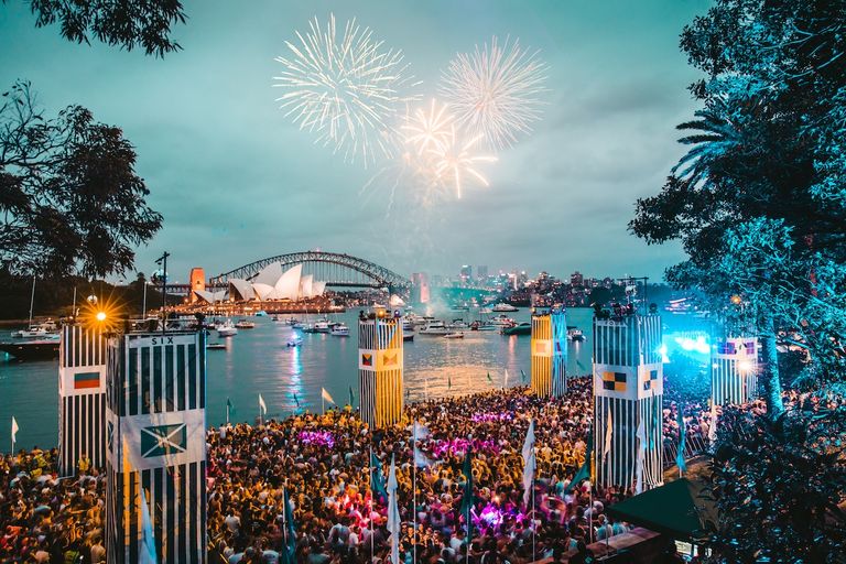 Fireworks explode over Sydney Harbour, Opera House, and Harbour Bridge as a large crowd celebrates at the Harbourlife 2016 music festival.